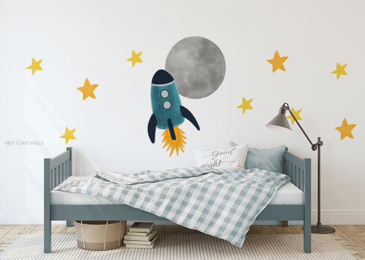 a child's bedroom with a bed and a rocket wall decal