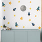 a child's room with a wall decorated with stars and rockets