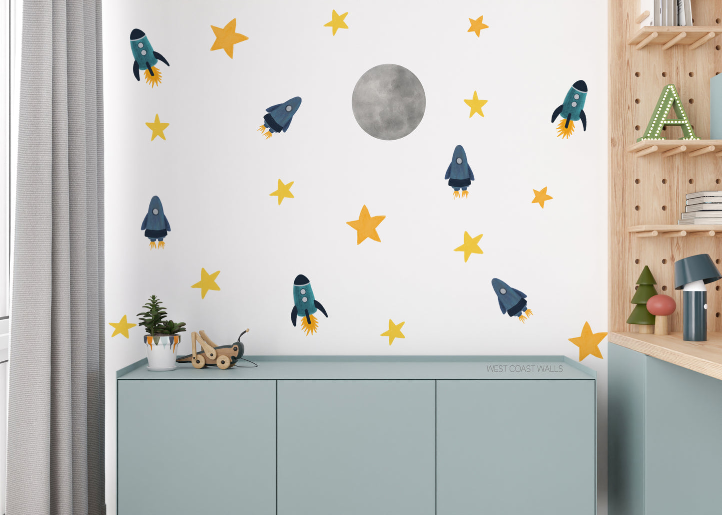 a child's room with a wall decorated with stars and rockets