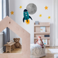 a child's bedroom with a rocket ship wall decal