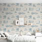 Young boy's bedroom with nature themed wallpaper in soft blue and off white color.