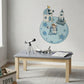 A children's room scene with a light gray wall decorated with a space-themed wall decal showing an astronaut, a moon base, and a rocket. A small gray table with wooden legs holds toy models, including a telescope, a model rocket, and an open book.