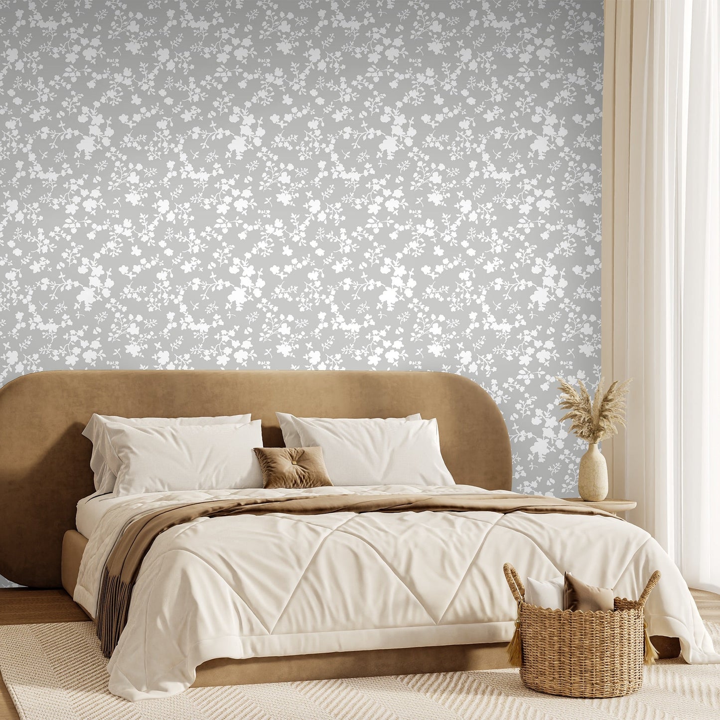 Modern bedroom with a brown upholstered bed and decorative pillows against a modern floral knockout style wallpaper in a warm grey and white