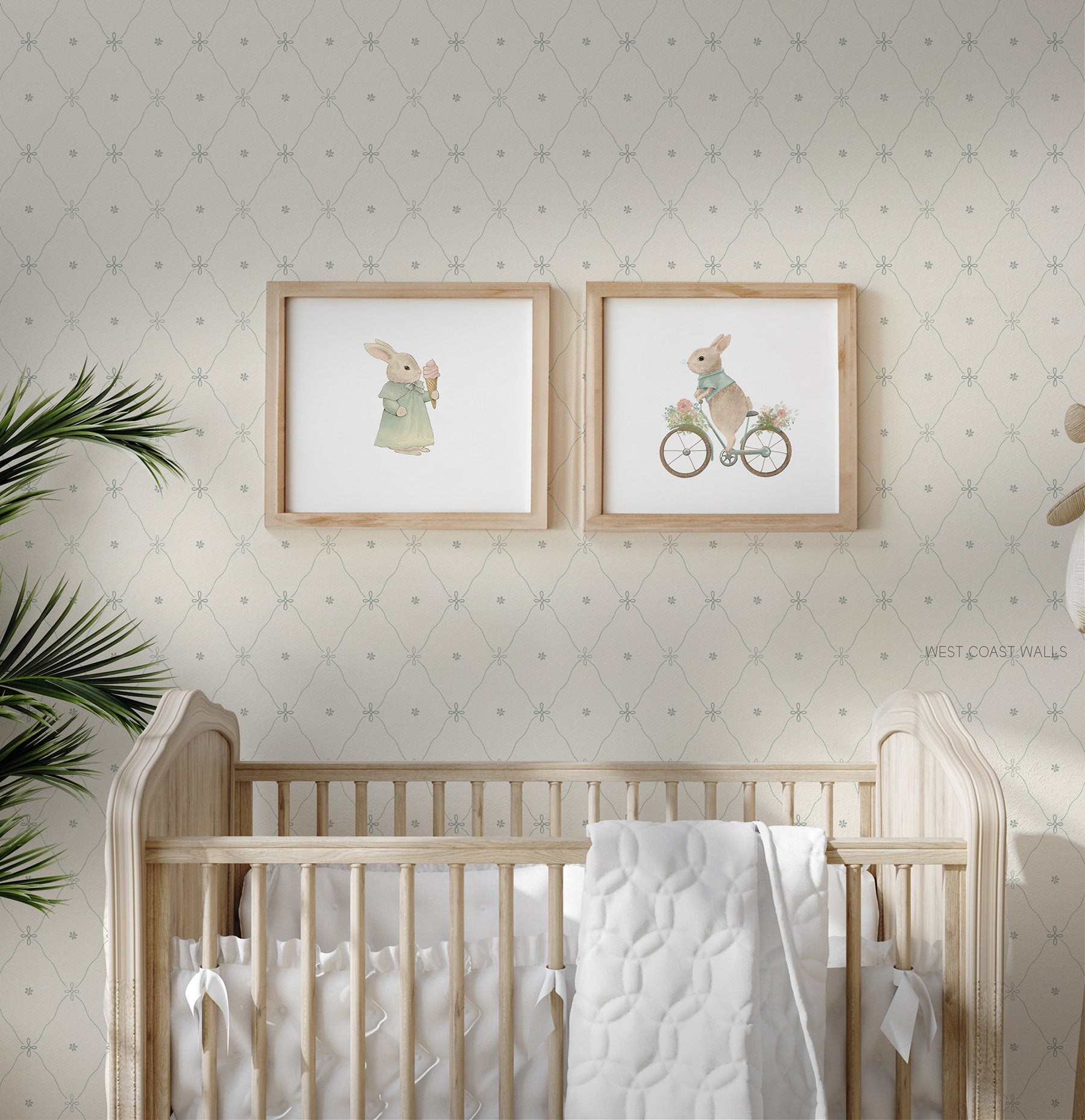 A soft blue floral lattice style wallpaper with a cream background styled in a nursery with a wooden crib and white bedding. 