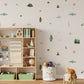 A styled children's room corner with a light wood shelving unit with storage bins set against a wall covered in whimsical camping and fishing-themed wall decals including fish, campfires, tents, ponds, trees, clouds, suns, and tents.