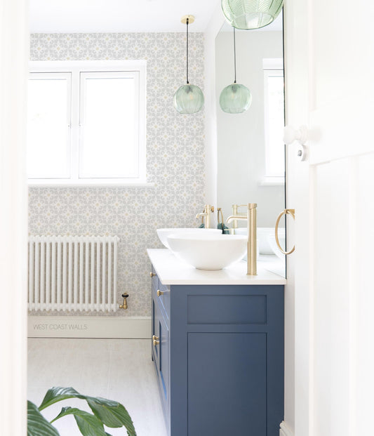 Grey blue starburst geometric tile design wallpaper with muted yellow accents.