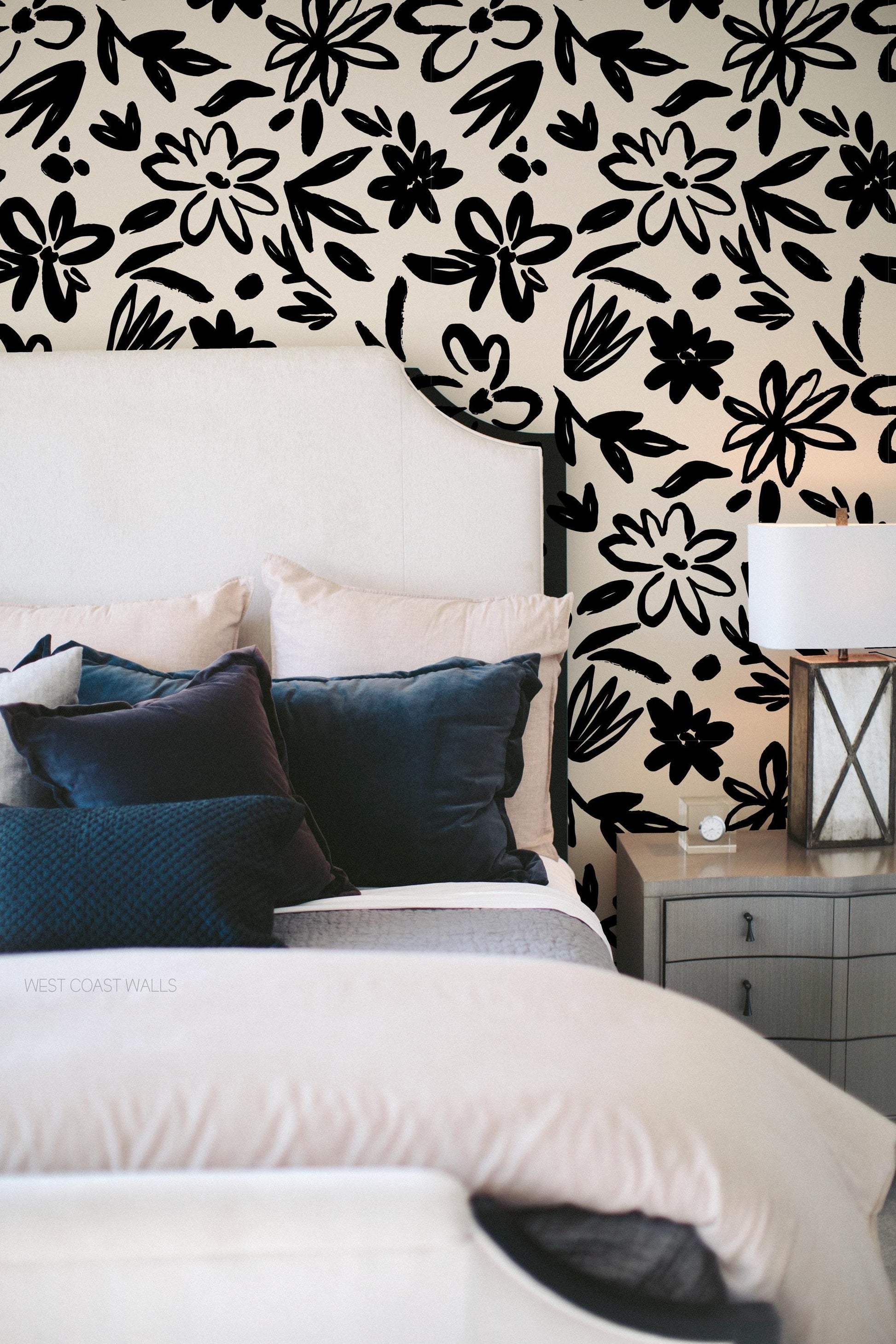 black and white bold floral wallpaper in a traditionally styled contemporary bedroom with blue accents