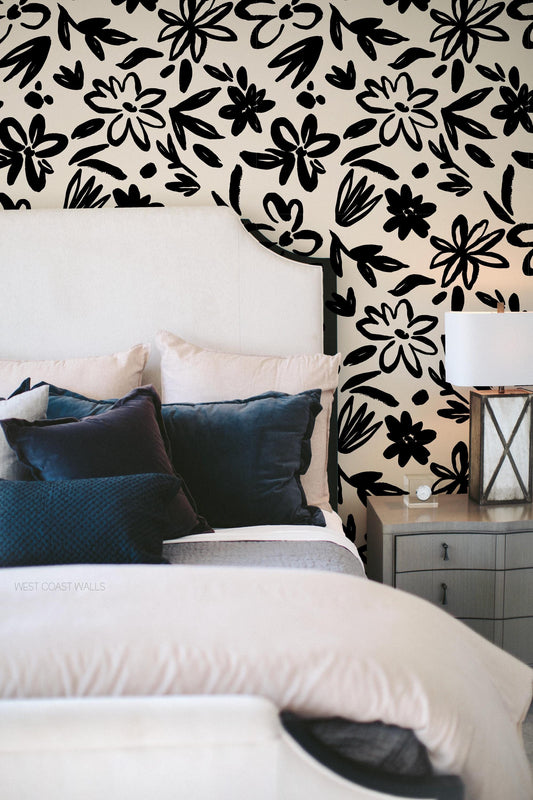 black and white bold floral wallpaper in a traditionally styled contemporary bedroom with blue accents