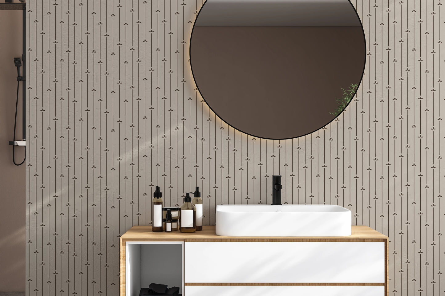 Modern bathroom vanity with round mirror and simple pinstripe beige and dark brown wallpaper with floral accents. 