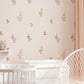 A nursery wall in soft pink tones is decorated with watercolor style duck and goose wall decals