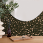 Round mirror with flat stylized overlapping vine wallpaper, wooden tray, and decorative items on a wooden surface.