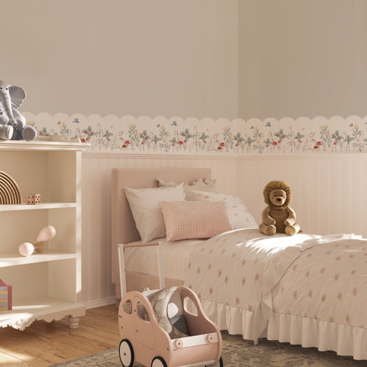 Children's bedroom with board and batten and a scalloped wallpaper border with bunnies, strawberries, and plants.