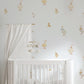 A white wooden baby crib in a nursery setting, decorated with whimsical duck and goose wall decals on a light gray wall. A white canopy curtain hangs from a wooden rod on the left, and a matching mobile hangs above the crib.